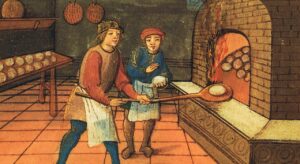 A baker at work in a medieval kitchen