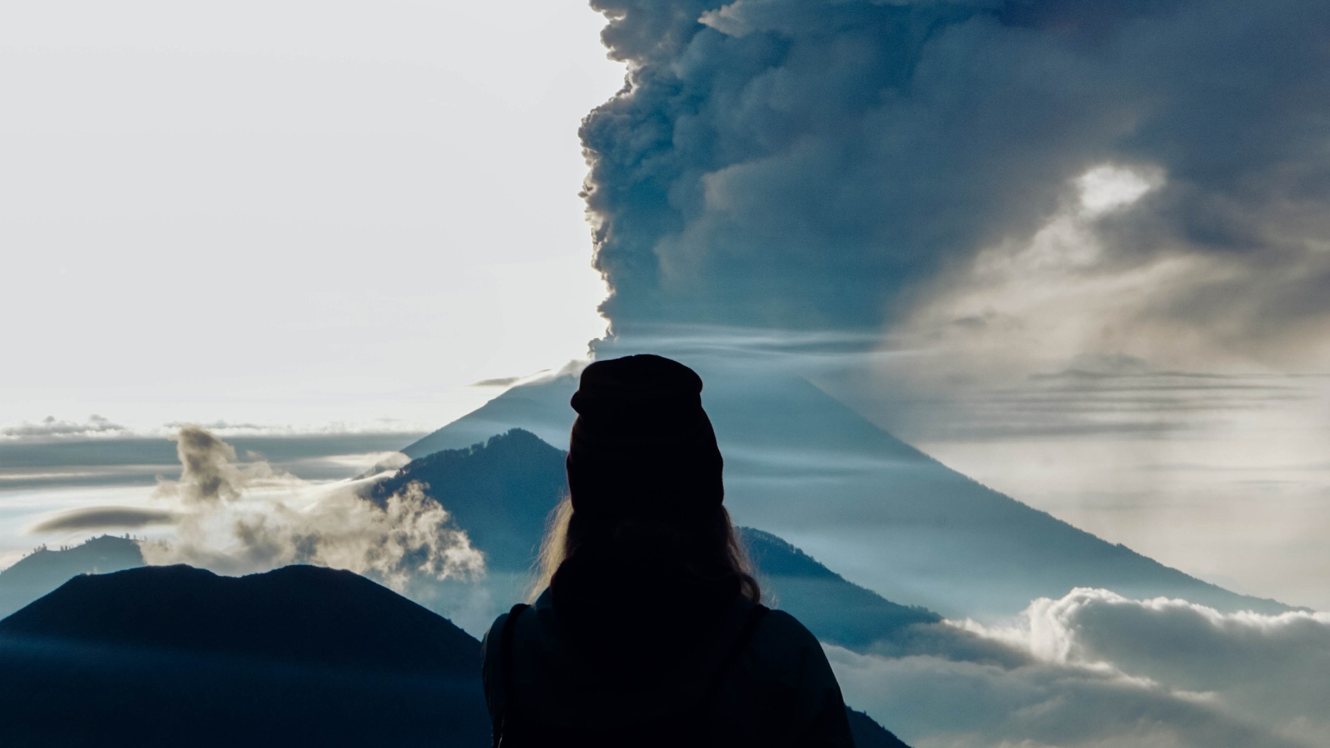 Girl staring at the eruption of a volcano. An explosion like this may have caused the volcanic winter of 536 CE.